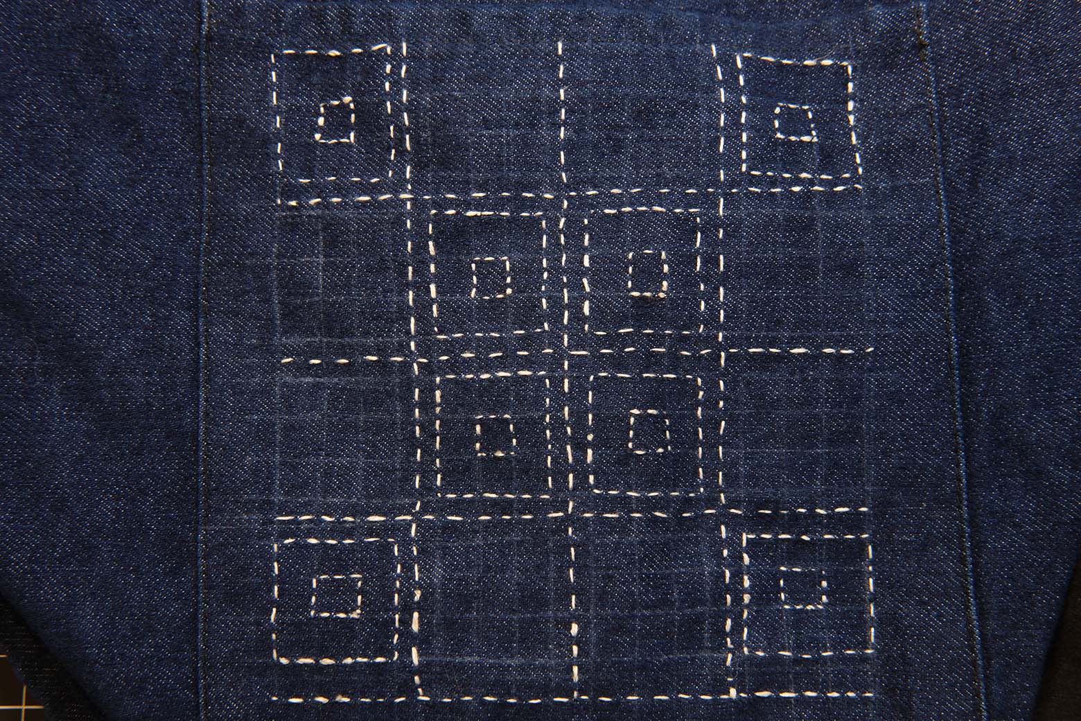 a piece of stitching on denim